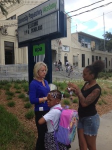 University Preparatory Academy leader Cheri Shannon talks to a parent during a recent school release in St. Petersburg, Fla. For many families, the school offers them hope that their child can get a good education.