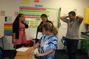 Academics Director Carolyn Scott, center, shares a laugh with teachers aide, Monica Garcia, left, and fourth-grade teacher Dennis McCartney.