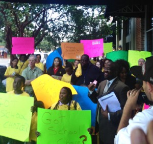 Scholarship supporters crowd outside union headquarters Thursday, protesting the announcement of the lawsuit.