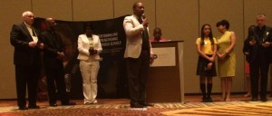 Flanked by Central Florida students and educators, Notre Dame ACE Academies director Rodney Pierre-Antoine announces plans to work with the Diocese of Orlando.