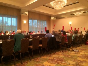 Members of the Florida School Boards Association raise placards and vote to leave the lawsuit challenging the state's tax credit scholarship program.